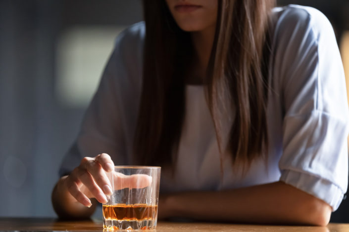 woman drinking alcoholic beverage