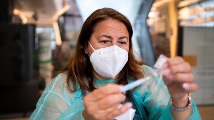 female doctor preparing covid-19 vaccine