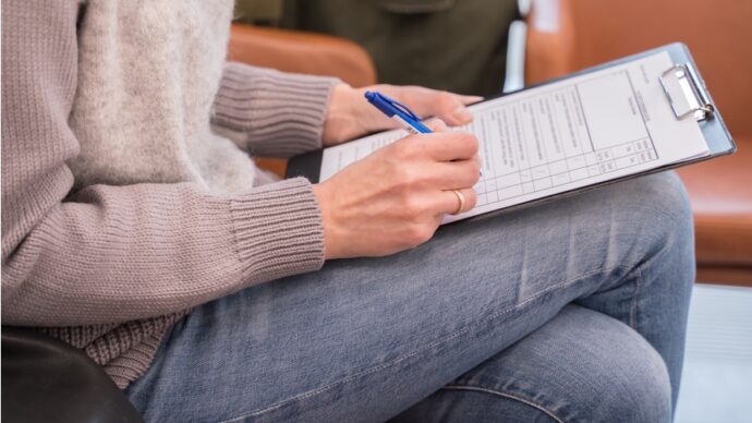 woman at doctors office filling out chart