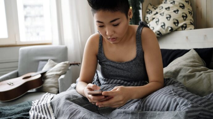 child on cell phone looking at social media