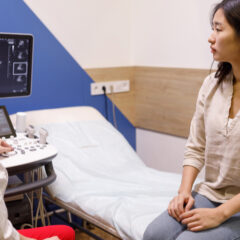 Woman and doctor looking at ultrasound