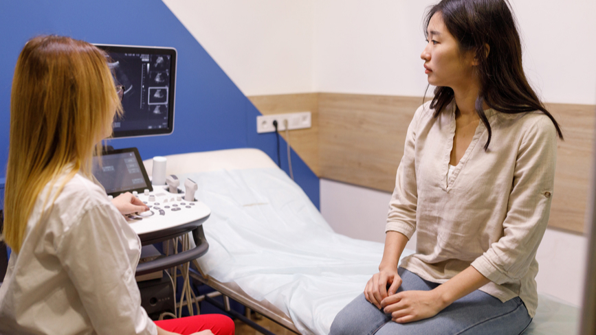 Woman and doctor looking at ultrasound