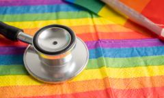 LGBTQ flag and stethoscope