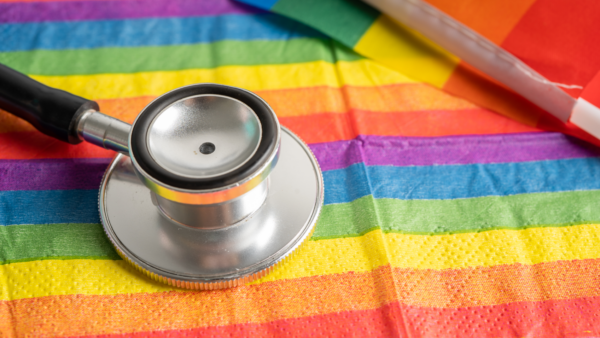 LGBTQ flag and stethoscope