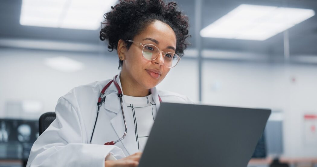 Doctor at medical practice using practice management software