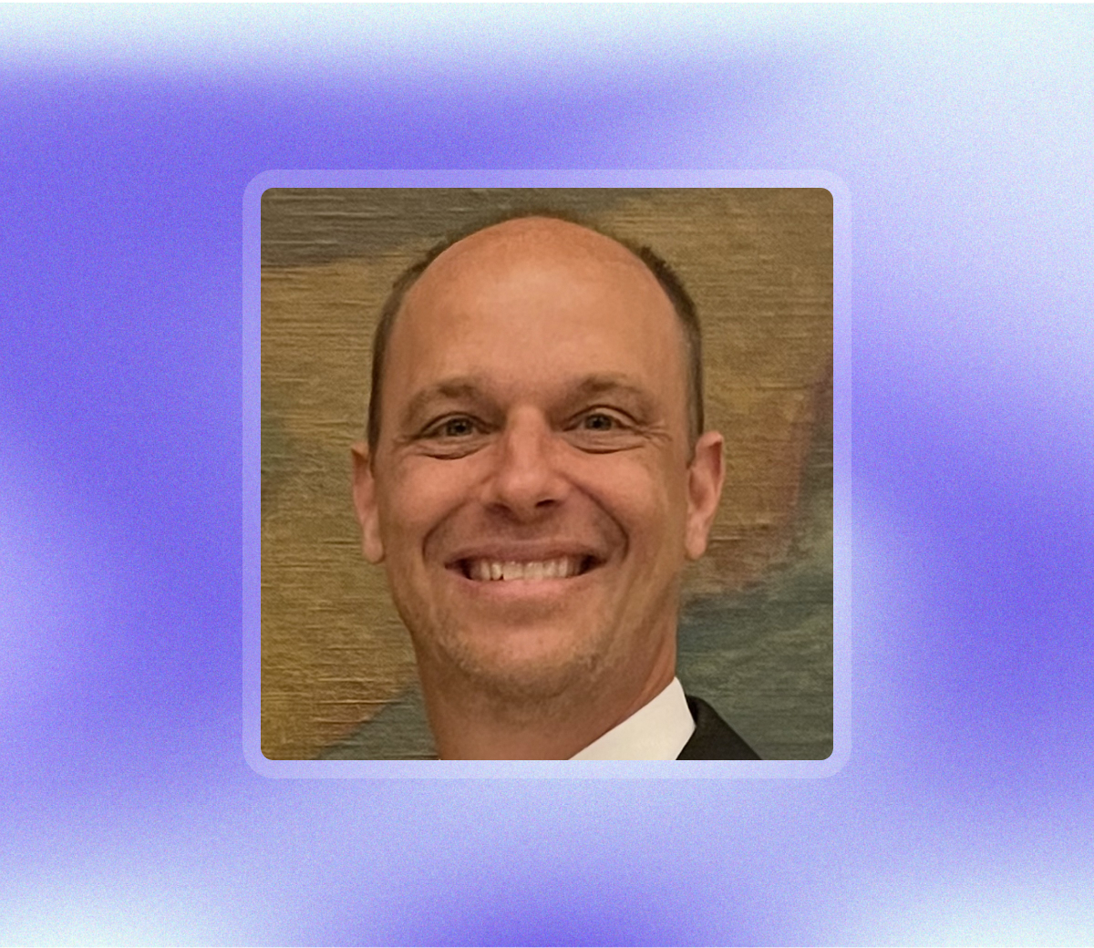 A smiling, balding doctor in a suit who has overcome feeling like he is not enough.